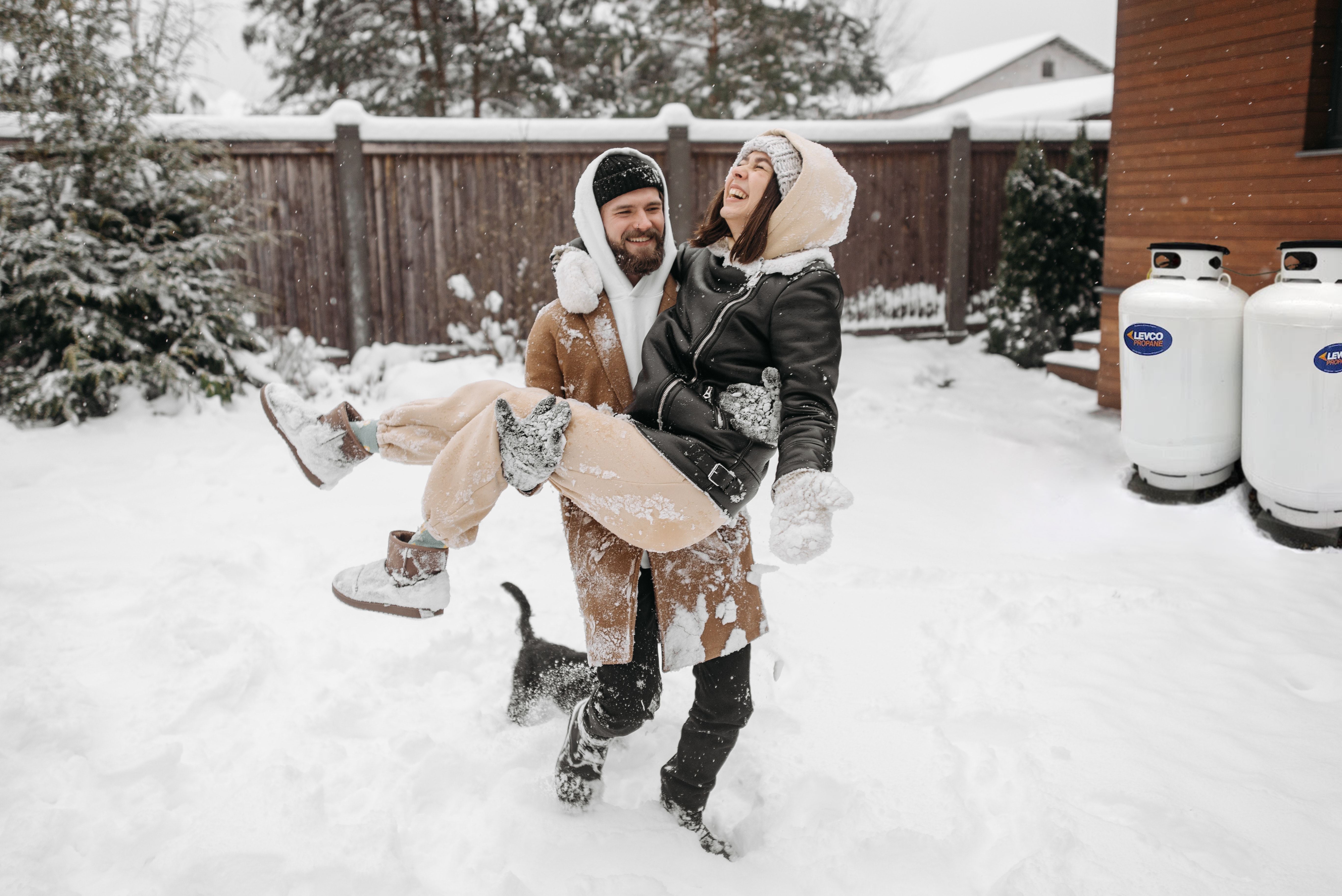 man carrying woman in the snow